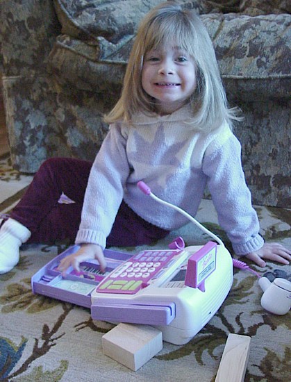 Dana playing with barbie cash register.jpg (78003 bytes)